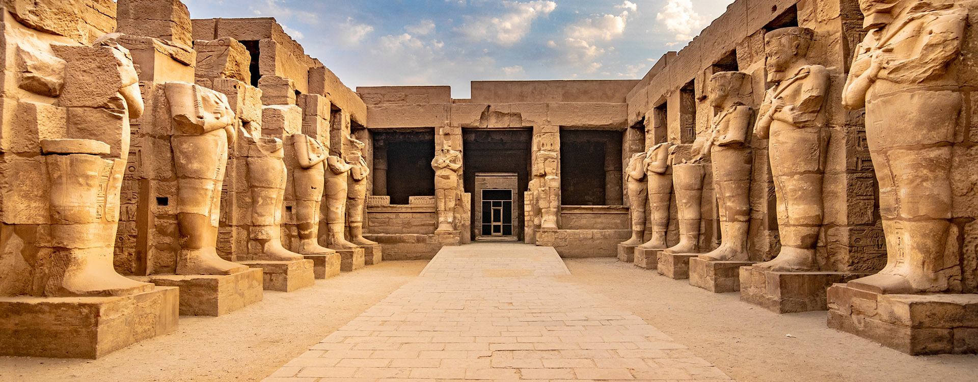 KARNAK TEMPLE - Large sculptures of pharaohs inside landmark with hieroglyphics and ancient symbols. Nile River and Luxor, Egypt