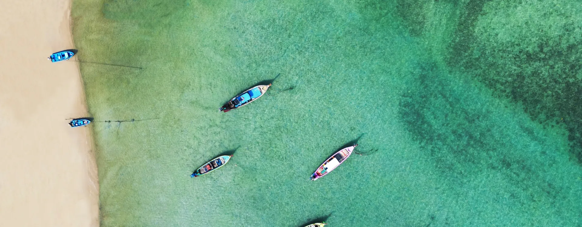 Aerial view over fishing boats on a luxury phuket holiday