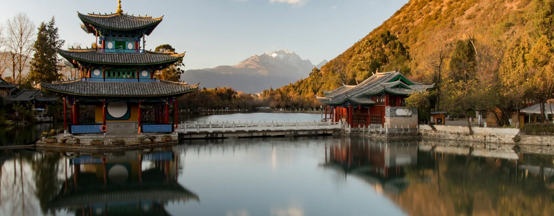 Beautiful traditional architecture with a mountainous background, Luxury Yunnan holidays