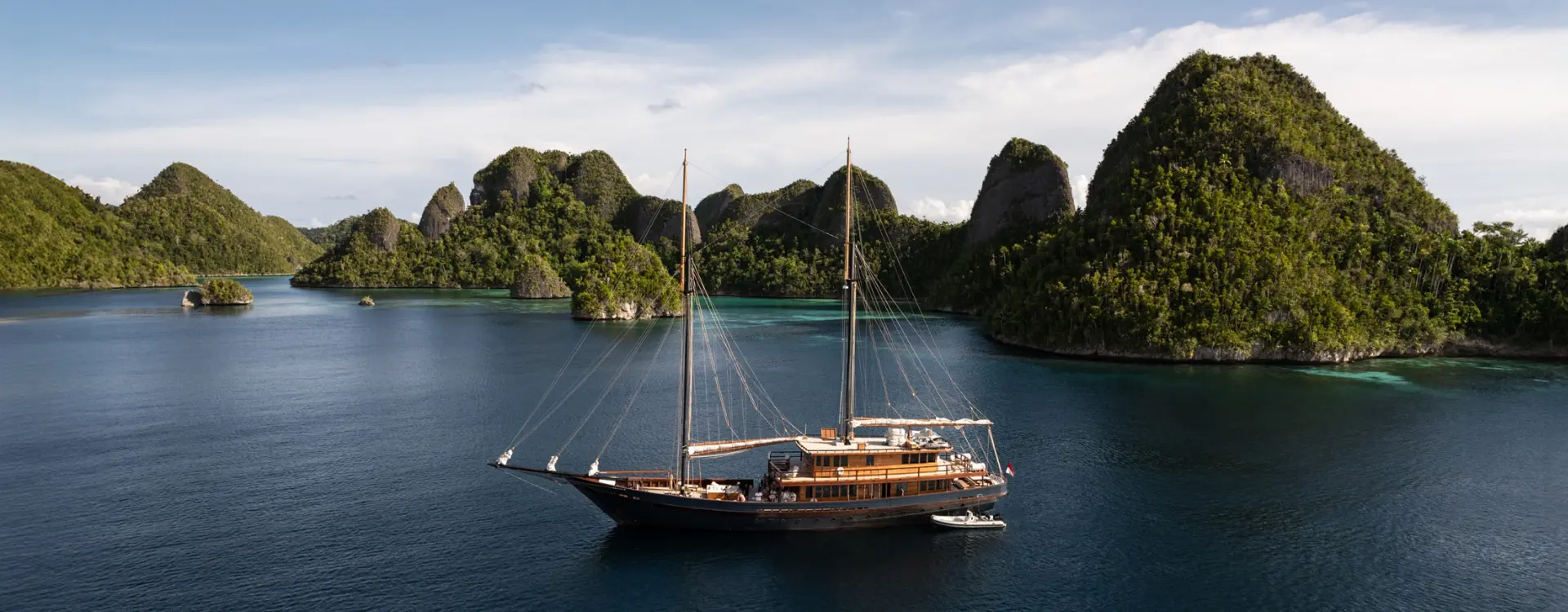 Indonesian inspired private sail yacht with indonesian island scenery